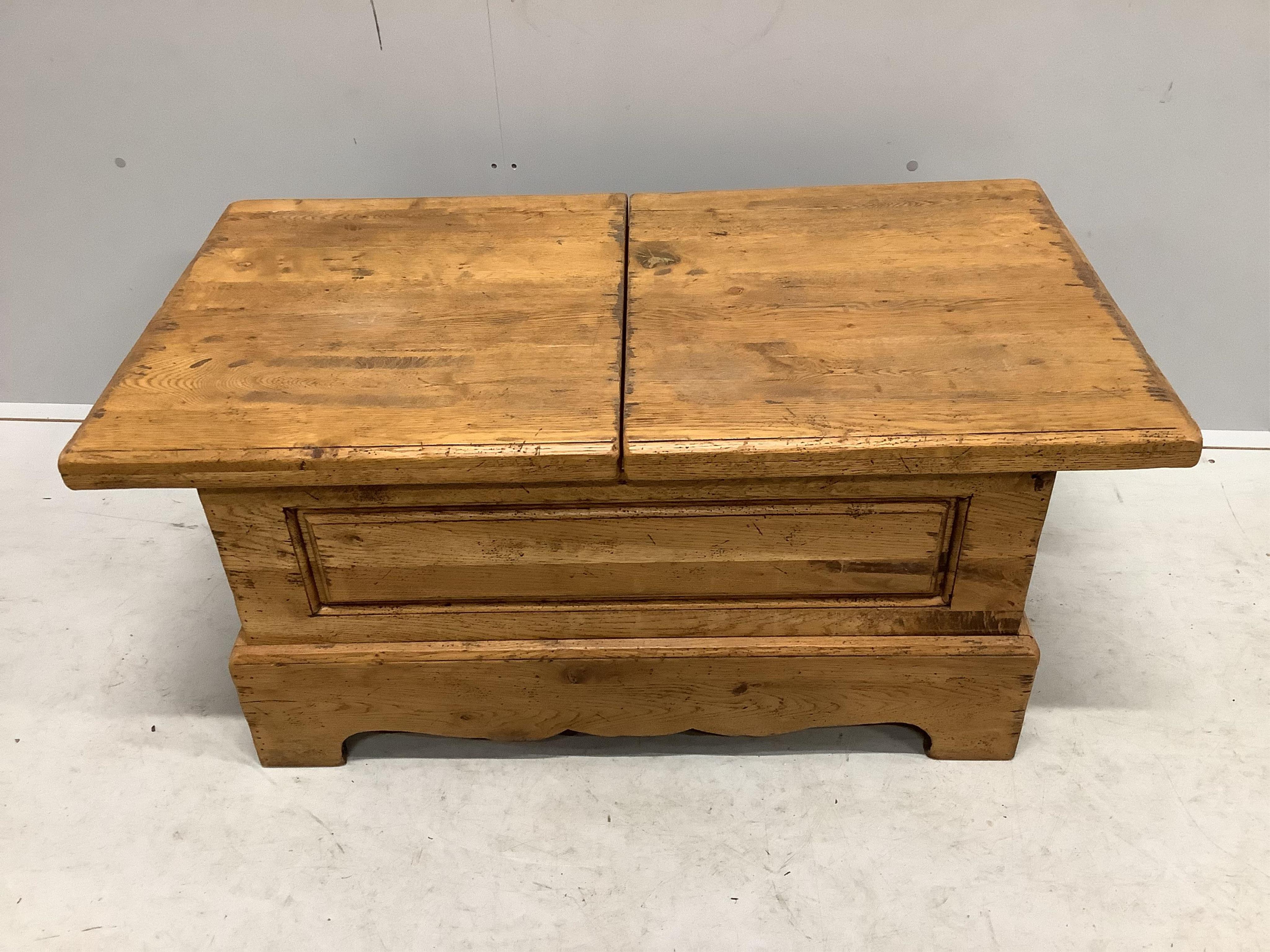 A Wesley Barrel pale oak twin hinged flap top storage coffee table, width 110cm, depth 60cm, height 48cm. Condition - fair